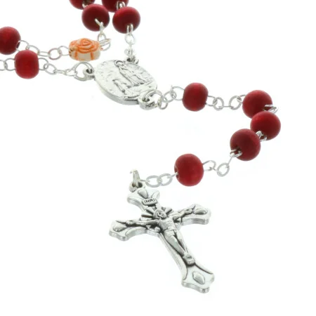 Rose-scented rosary in a glass bottle