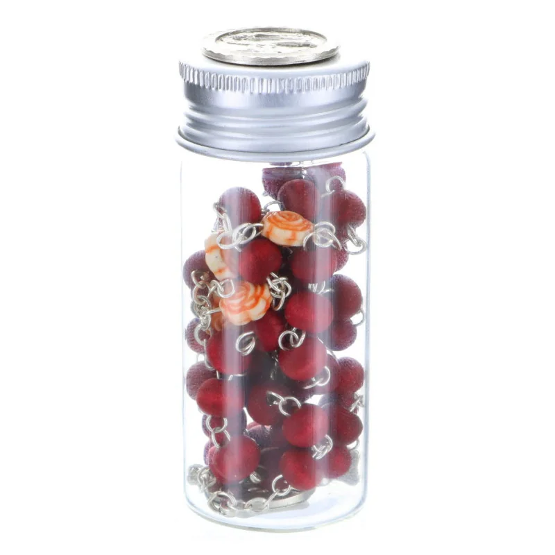 Rose-scented rosary in a glass bottle